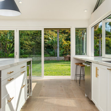 AG BiFold Patio Door & Window Pairing Connects All-White Kitchen to the Outdoors