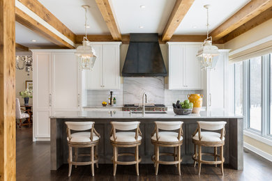 Design ideas for a traditional kitchen in Minneapolis with flat-panel cabinets, white cabinets, quartzite benchtops, white splashback, stone slab splashback, panelled appliances, dark hardwood floors, with island and white benchtop.