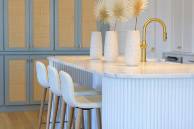 Inspiration for a large transitional galley light wood floor open concept kitchen remodel in Charleston with raised-panel cabinets, blue cabinets, quartzite countertops and an island