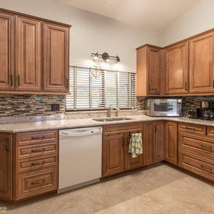 Mid-sized traditional kitchen pantry remodeling - Inspiration for a mid-sized timeless u-shaped porcelain floor kitchen pantry remodel in Orlando with an undermount sink, raised-panel cabinets, medium tone wood cabinets, quartz countertops, multicolored backsplash and no island
