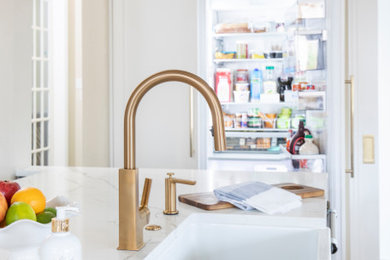 Inspiration for a large transitional l-shaped porcelain tile and multicolored floor eat-in kitchen remodel in Dallas with a farmhouse sink, shaker cabinets, white cabinets, quartz countertops, white backsplash, subway tile backsplash, stainless steel appliances, an island and white countertops