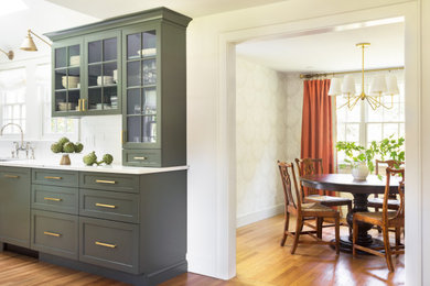 Inspiration for a transitional kitchen in Boston with shaker cabinets, green cabinets, quartz benchtops, white splashback, ceramic splashback, panelled appliances, with island and white benchtop.