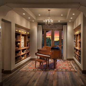 The Music Room/Library is seen through corbeled arched opening, with reclaimed w
