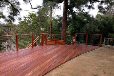 Example of a mid-sized mountain style backyard deck design in Los Angeles with no cover