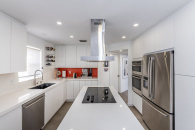 Eat-in kitchen - mid-sized contemporary galley concrete floor and gray floor eat-in kitchen idea in Miami with a single-bowl sink, flat-panel cabinets, white cabinets, granite countertops, orange backsplash, an island and white countertops