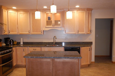 Enclosed kitchen - transitional u-shaped vinyl floor enclosed kitchen idea in Chicago with a double-bowl sink, shaker cabinets, light wood cabinets, granite countertops, stainless steel appliances and an island