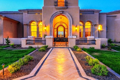 Mid-sized tuscan beige one-story stucco exterior home photo in Phoenix