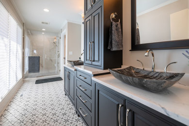 Inspiration for a mid-sized contemporary master white tile and ceramic tile ceramic tile, gray floor and double-sink bathroom remodel in Cedar Rapids with black cabinets, a one-piece toilet, gray walls, a vessel sink, quartz countertops, a hinged shower door, white countertops and a freestanding vanity