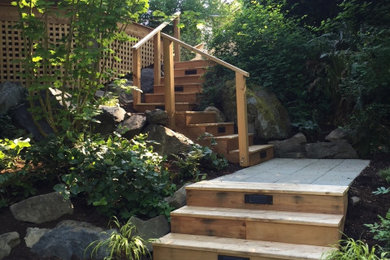 Inspiration for a wooden l-shaped wood railing staircase remodel in Seattle with wooden risers