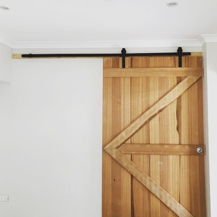 Example of a trendy enclosed ceramic floor and gray floor home theater design in Townsville with white walls