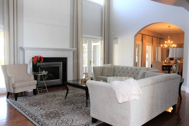 Large transitional open concept dark wood floor and brown floor living room photo in Other with gray walls, a standard fireplace and a tv stand