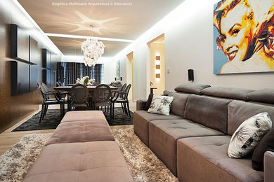 Mid-sized trendy loft-style light wood floor and brown floor living room photo in Other with white walls, a two-sided fireplace, a wood fireplace surround and a media wall