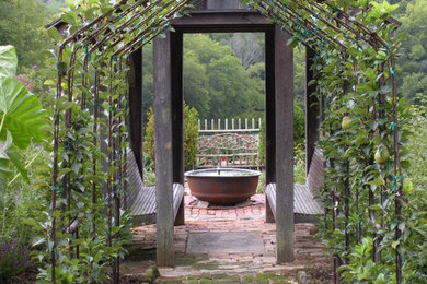 This is an example of a rustic partial sun brick garden path in Nashville.