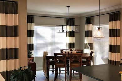 Inspiration for a mid-sized transitional porcelain tile and beige floor kitchen/dining room combo remodel in Tampa with gray walls, no fireplace and a wood fireplace surround