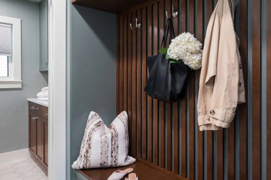 Mid-sized transitional porcelain tile, white floor and wood wall mudroom photo in Dallas with green walls