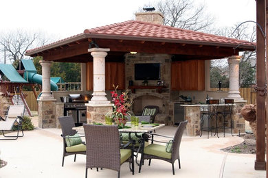 Patio kitchen - large mediterranean backyard concrete patio kitchen idea in Dallas with a gazebo