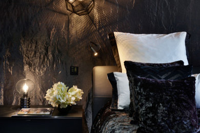 Photo of a contemporary master bedroom in London with black walls.