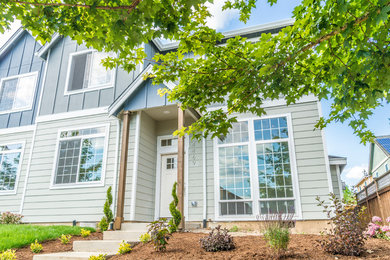 Inspiration for a mid-sized transitional blue two-story wood exterior home remodel in Portland with a shingle roof