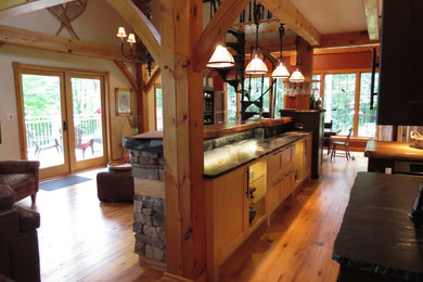 Example of a large mountain style u-shaped light wood floor eat-in kitchen design in Toronto with shaker cabinets, granite countertops, stone tile backsplash, an island, an undermount sink, light wood cabinets, gray backsplash and stainless steel appliances