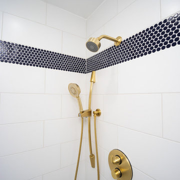 Horizontal shower feature strip created with penny round mosaic tile