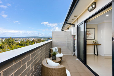 Small contemporary balcony in Sydney with with privacy feature.