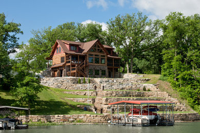 Inspiration for a large rustic brown two-story wood gable roof remodel in Other