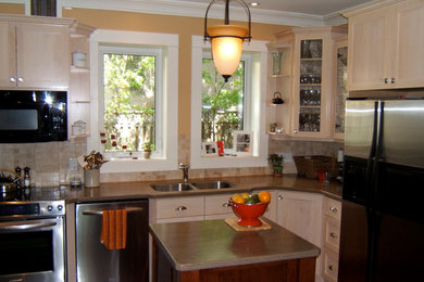 Elegant l-shaped eat-in kitchen photo in Toronto with an undermount sink, shaker cabinets, light wood cabinets, granite countertops, beige backsplash, stone tile backsplash and stainless steel appliances