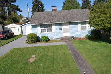 This is an example of a full sun front yard water fountain landscape in Seattle.