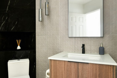 Powder room - small modern beige tile and ceramic tile ceramic tile and beige floor powder room idea in Seattle with flat-panel cabinets, medium tone wood cabinets, a one-piece toilet, white walls, an undermount sink, quartz countertops, white countertops and a floating vanity