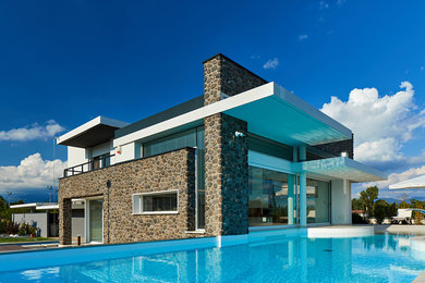 This is an example of a contemporary exterior in Other with stone veneer.
