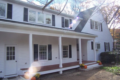 Inspiration for a large cottage white two-story wood exterior home remodel in Boston with a shingle roof