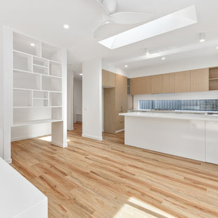 Idee per un piccolo soggiorno minimalista aperto con pareti rosse, camino classico, cornice del camino in intonaco e parete attrezzata