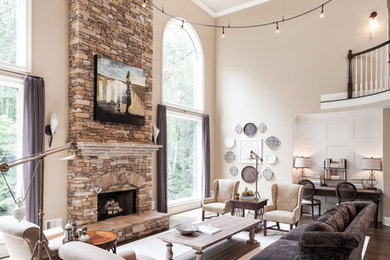 Large transitional formal and open concept dark wood floor and brown floor living room photo in Atlanta with beige walls, a standard fireplace, a stone fireplace and no tv