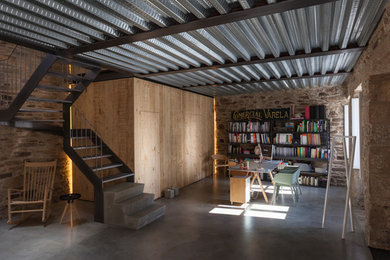 Inspiration for a mid-sized industrial freestanding desk concrete floor study room remodel in Other with beige walls