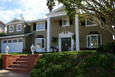 Mid-sized traditional green two-story concrete fiberboard exterior home idea in San Diego