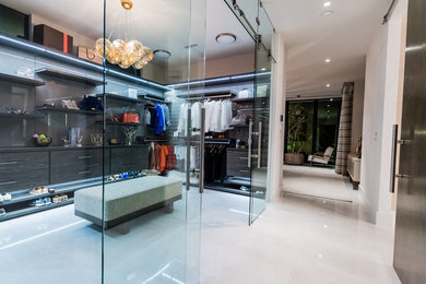 Dressing room - huge modern marble floor and gray floor dressing room idea in Miami with flat-panel cabinets and dark wood cabinets