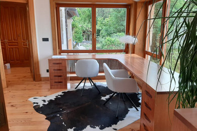 Foto de despacho clásico renovado de tamaño medio con paredes blancas, suelo de madera clara y escritorio independiente
