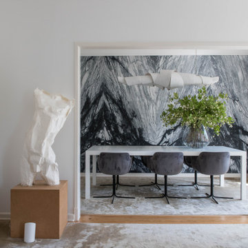 Casa da Moeda dining room with dark table, chairs and stone wall