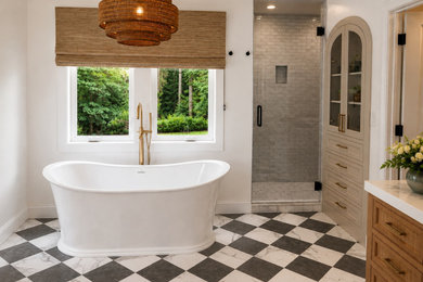Freestanding bathtub - mid-sized contemporary freestanding bathtub idea with furniture-like cabinets, brown cabinets and a built-in vanity