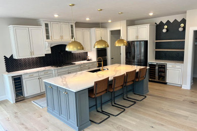 Example of a transitional kitchen design in Other with shaker cabinets, white cabinets, quartz countertops, black backsplash and an island