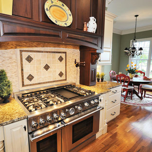 Large kitchen pantry photos - Large l-shaped medium tone wood floor kitchen pantry photo in Sacramento with an undermount sink, raised-panel cabinets, dark wood cabinets, wood countertops, white backsplash, ceramic backsplash, stainless steel appliances and an island