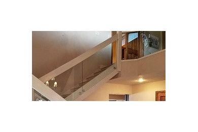 Inspiration for a mid-sized contemporary wooden straight glass railing staircase remodel in Other with wooden risers