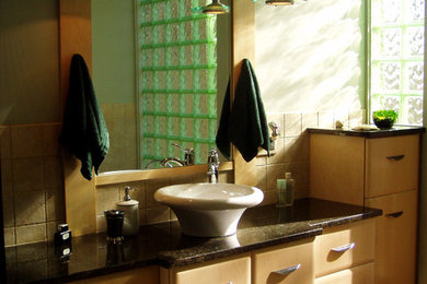 Inspiration for a mid-sized contemporary master beige tile and ceramic tile slate floor bathroom remodel in Cleveland with light wood cabinets, granite countertops, a vessel sink and flat-panel cabinets