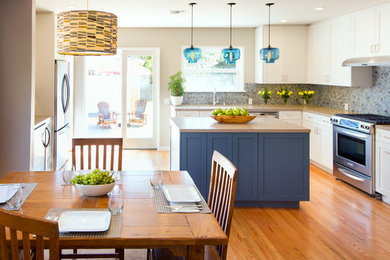 Large transitional u-shaped light wood floor eat-in kitchen photo in Los Angeles with shaker cabinets, white cabinets, gray backsplash, matchstick tile backsplash, stainless steel appliances, an island and an undermount sink
