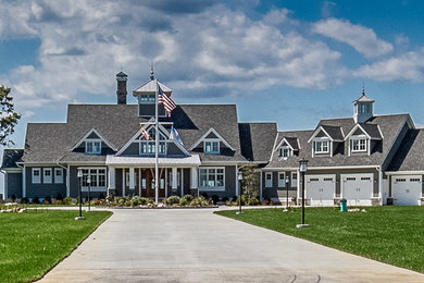 Inspiration for a huge coastal gray two-story wood exterior home remodel in Baltimore with a mixed material roof