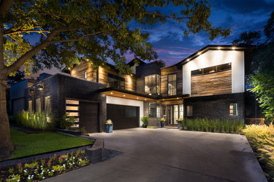 Large contemporary two-storey brick multi-coloured exterior in Dallas with a flat roof.