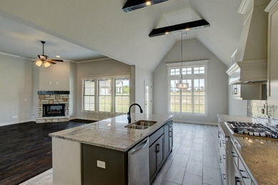 Open concept kitchen - mid-sized contemporary galley porcelain tile open concept kitchen idea in Other with a double-bowl sink, recessed-panel cabinets, white cabinets, granite countertops, beige backsplash, ceramic backsplash, stainless steel appliances and an island