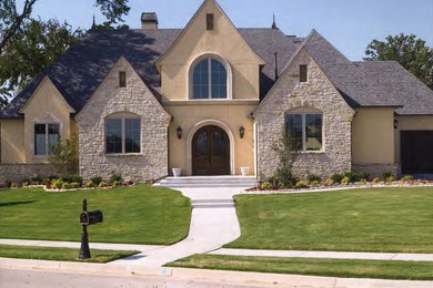 Mid-sized rustic beige two-story mixed siding gable roof idea in Oklahoma City