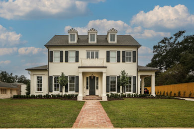 Large traditional white two-story brick house exterior idea with a shingle roof and a gray roof