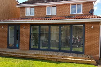 Photo of a modern one-storey brick exterior in Hampshire with a tile roof.